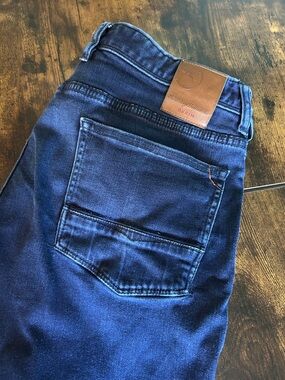 Tommy Bahama Men's Slim Jeans in Dark Blue with Brown Leather Patch